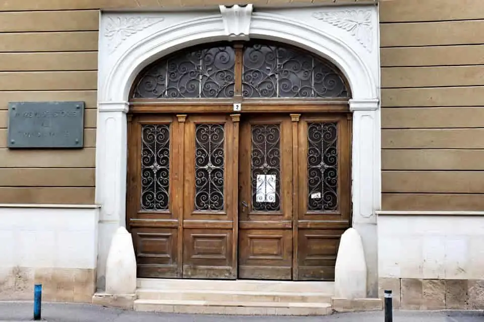 Entrance to Ethnography Museum in Cluj Napoca, two large wooden doors.