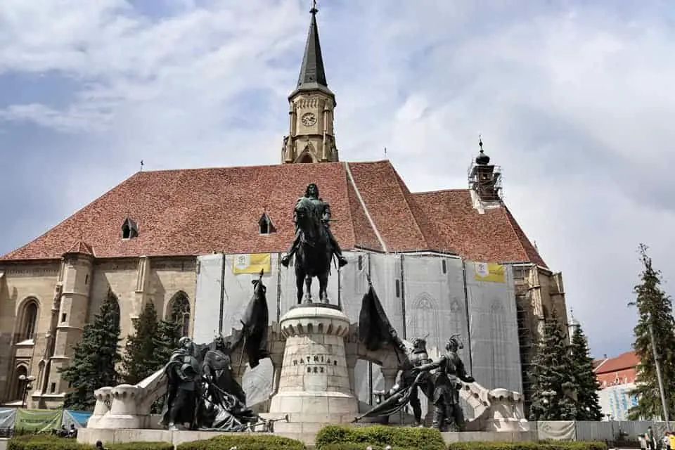 St. Michael's Church behind the Matthias Corvinus statue in Piata Unirii, Cluj-Napoca, Romania