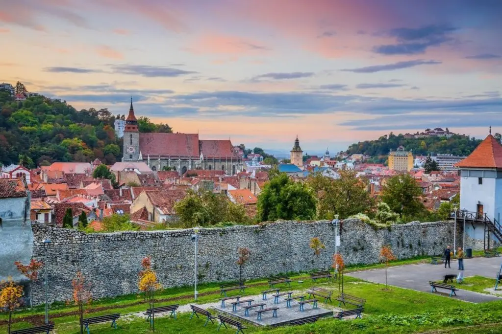 Brasov Old Town seen during sunset overlooking the city walls.