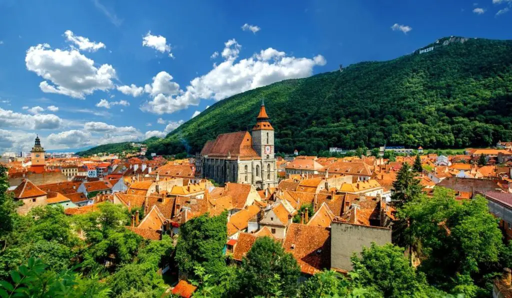 Red rooftops of Brasov in the forest-covered mountains of Transylvania.