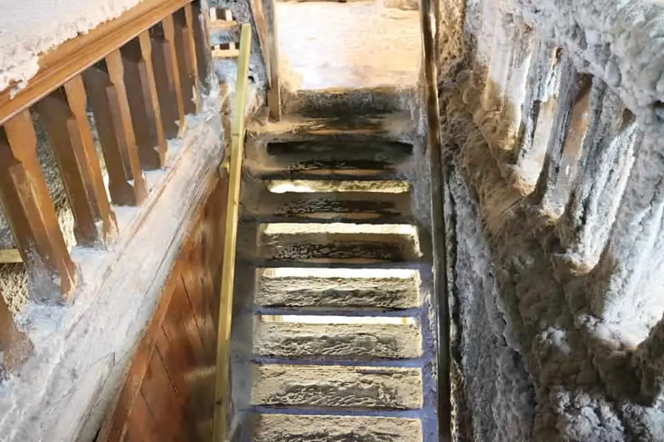 Stairs in Turda Salt Mine covered in salt deposits.