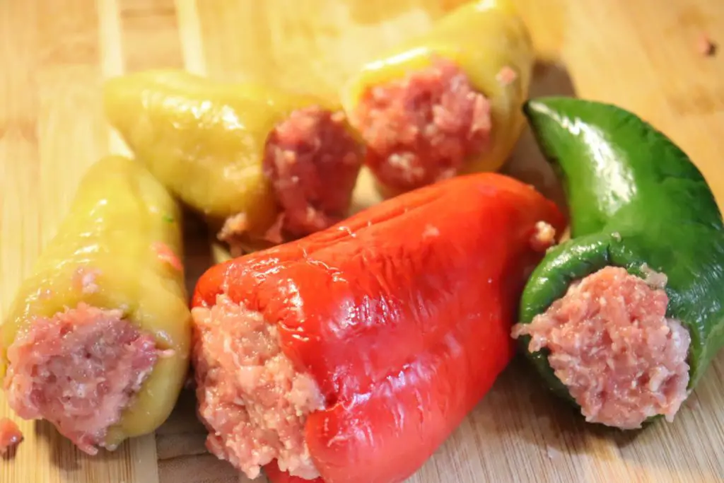 red, green, and yellow peppers stuffed with ground meat mixture