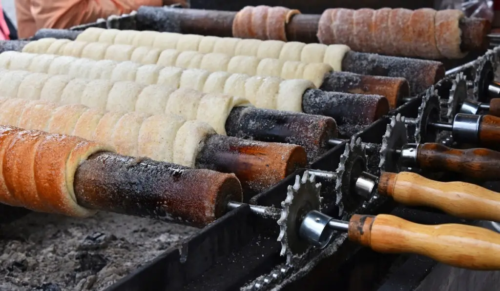 Kurtoskalacs roasting on a spit in Rimetea Village, Romania.