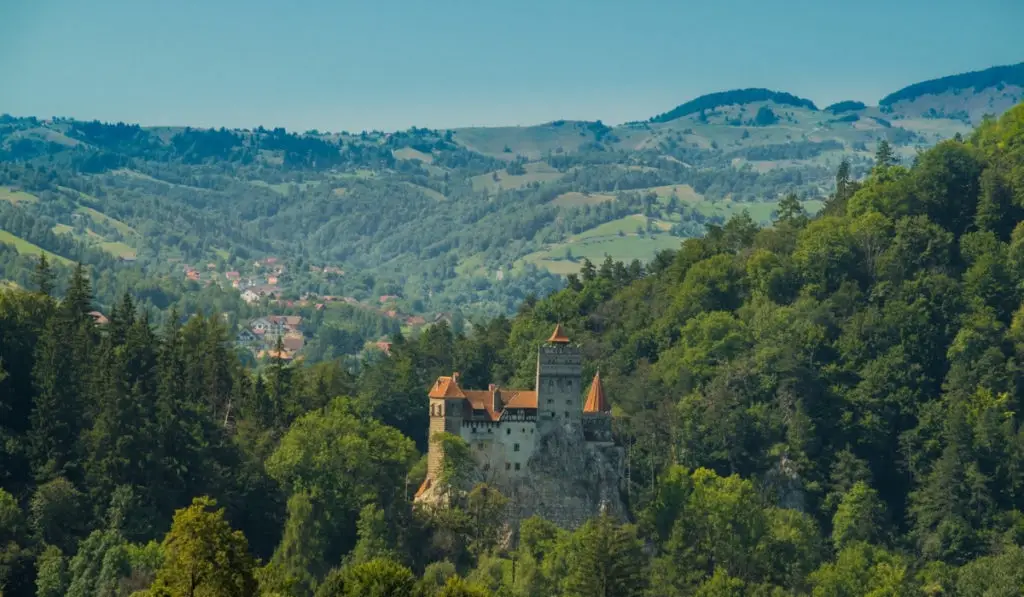 Bran Castle in an aerial shot seen through the Transylvanian forests.