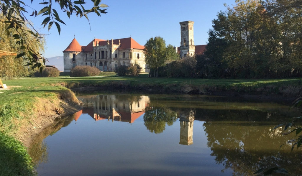 Banffy Castle in Transylvania with its reflection in a pond.