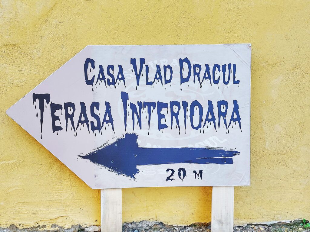 Sign directing tourists to Casa Vlad Dracul, Dracula's birth house in Sighisoara, Romania.