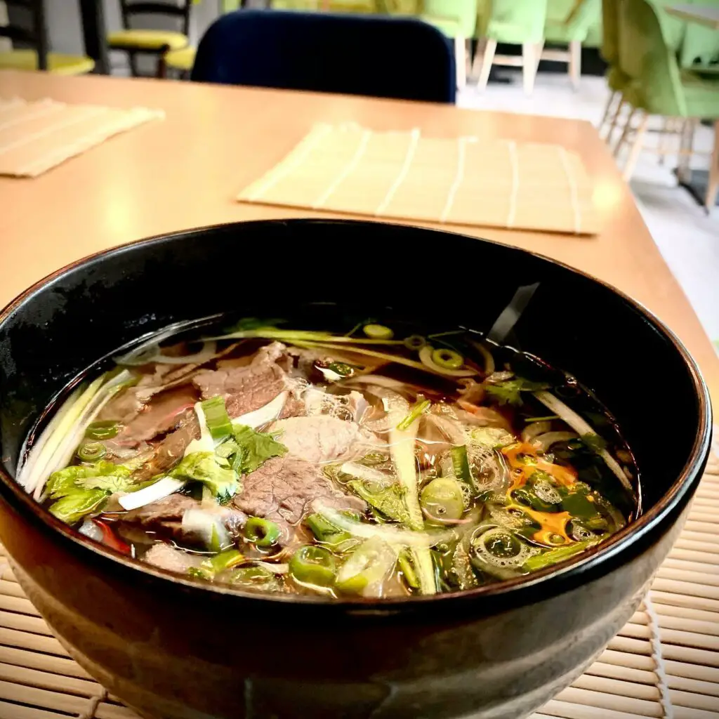 Big bowl of beef pho at Vietnamese restaurant in Cluj-Napoca.