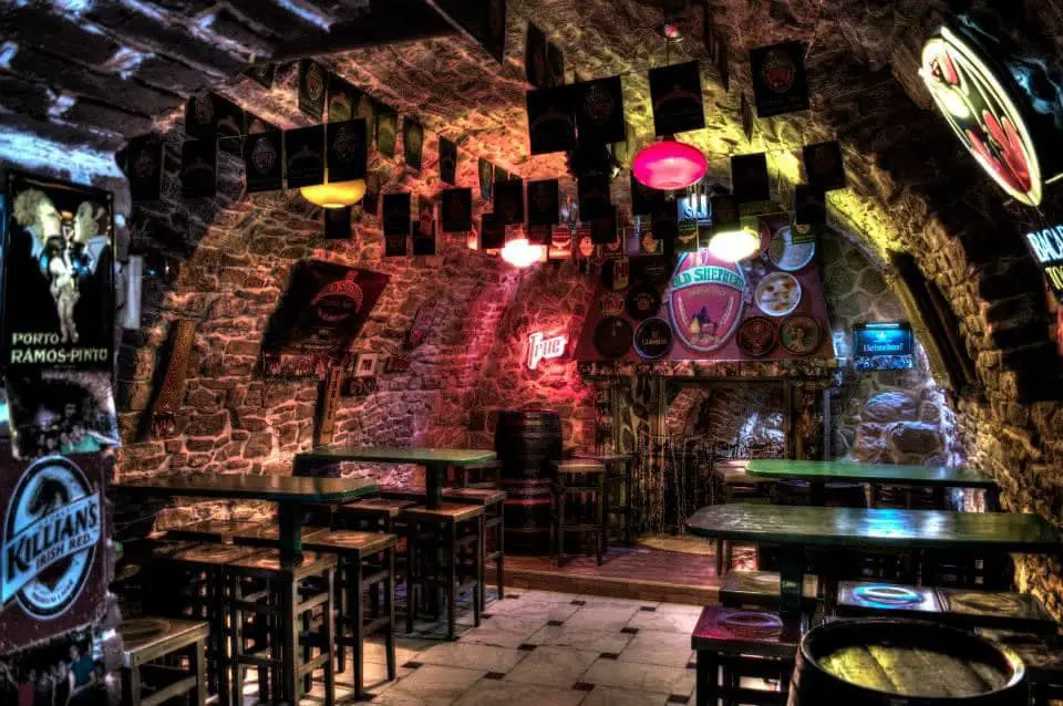 Cave-like bar with many signs on the walls in Cluj-Napoca.