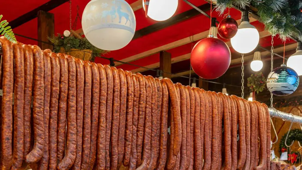 Sausages hanging beneath Christmas ornaments in Romania.