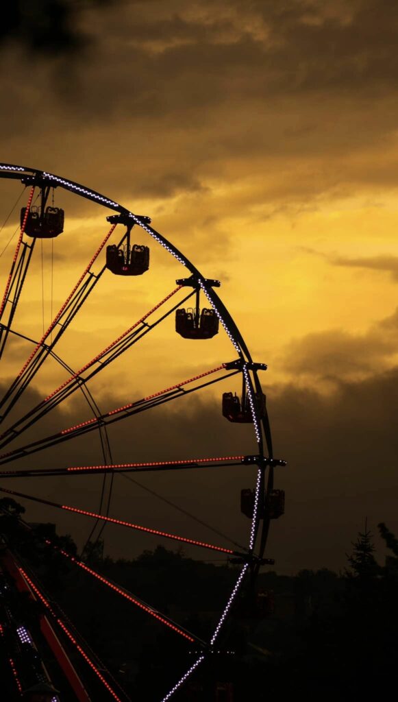 Ferris wheel at Untold against a yellow hazy sky.