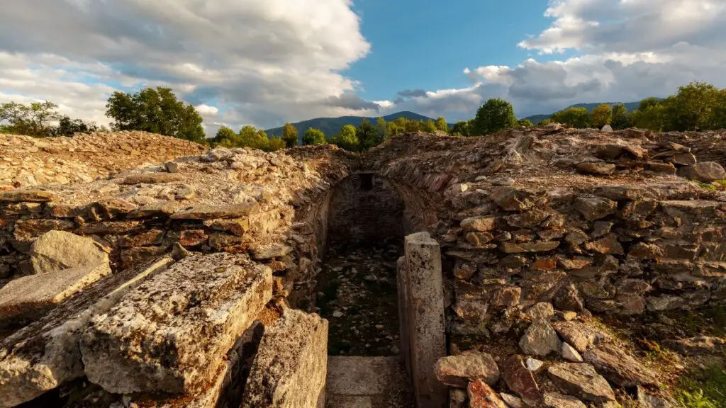 Ancient ruins under blue sky at Sarmizegetusa Regia.