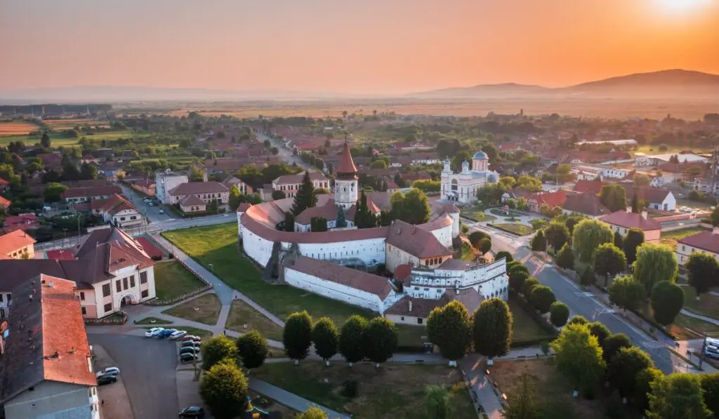 Prejmer village and fortified church at sunset from an aerial shot.