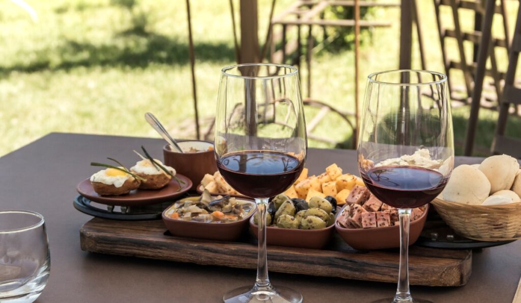 Wine lunch on a vineyard with a platter of appetizers at Jidvei winery.